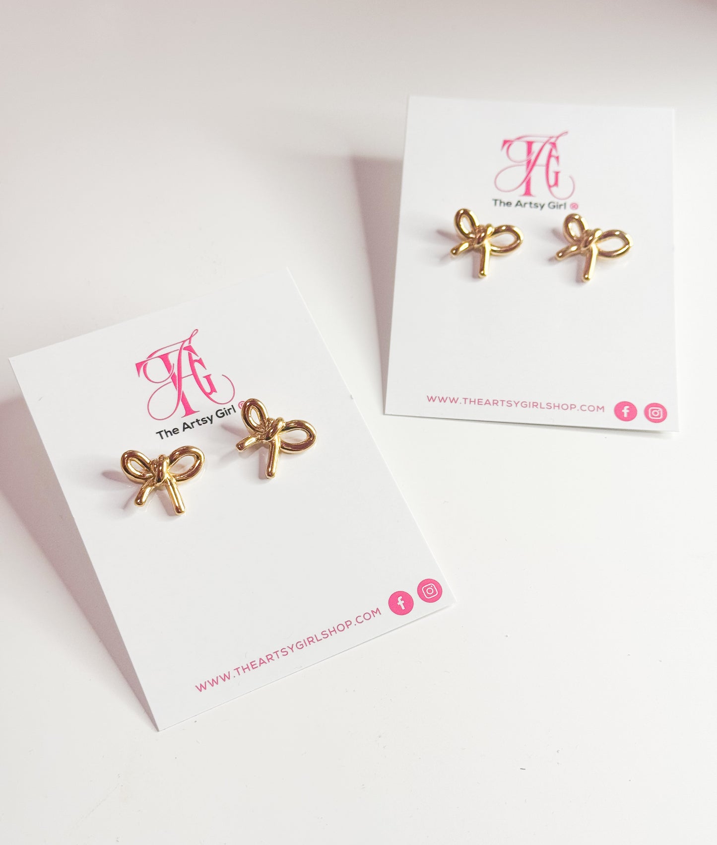 Close-up image of gold tarnish-free bow stud earrings with a sleek, shiny finish. These delicate earrings feature a classic bow design, perfect for adding a touch of elegance and charm to any outfit.