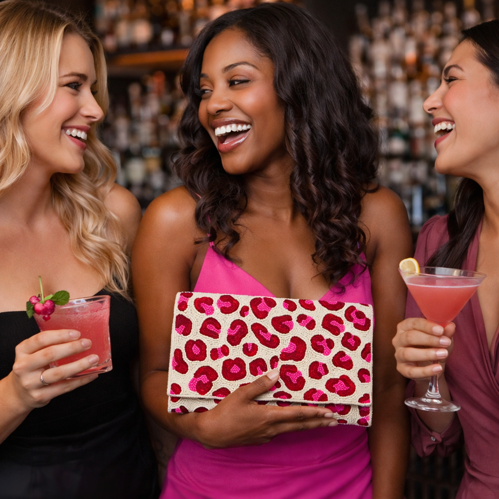 Woman in a hot pink dress holding a pink and red spotted beaded clutch while out at a bar with friends, styled for a girls night out.