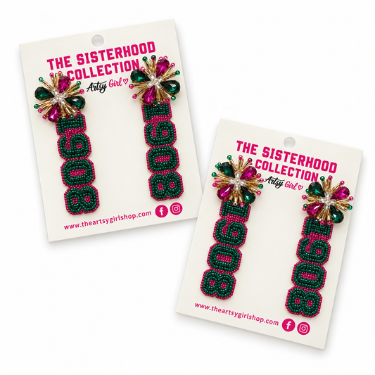 Two pairs of beaded letter earrings spelling '1908' with a floral embellishment, displayed on white backing cards that read 'THE SISTERHOOD COLLECTION' and 'The Artsy Girl'.