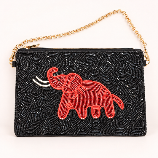 A black beaded clutch bag with a gold chain strap, featuring a red beaded elephant design on the front.