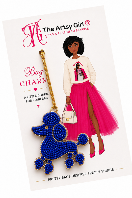 Blue beaded poodle bag charm on a white card with 'The Artsy Girl' branding.