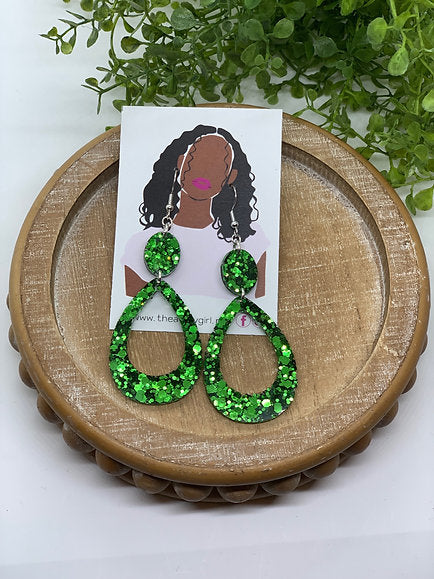 Green dangling earrings named ‘3/17 Special,’ featuring intricate design with both metals intertwined, creating a unique and elegant look.