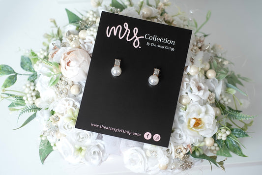 A Couple of Forevers pearl stud earrings featuring faux pearls and CZ accents, perfect for adding a touch of elegance and sophistication to any outfit.