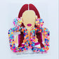 A pair of multicolored round square earrings with a glittery finish, featuring a design that resembles a woman's profile with earrings and a name tag.