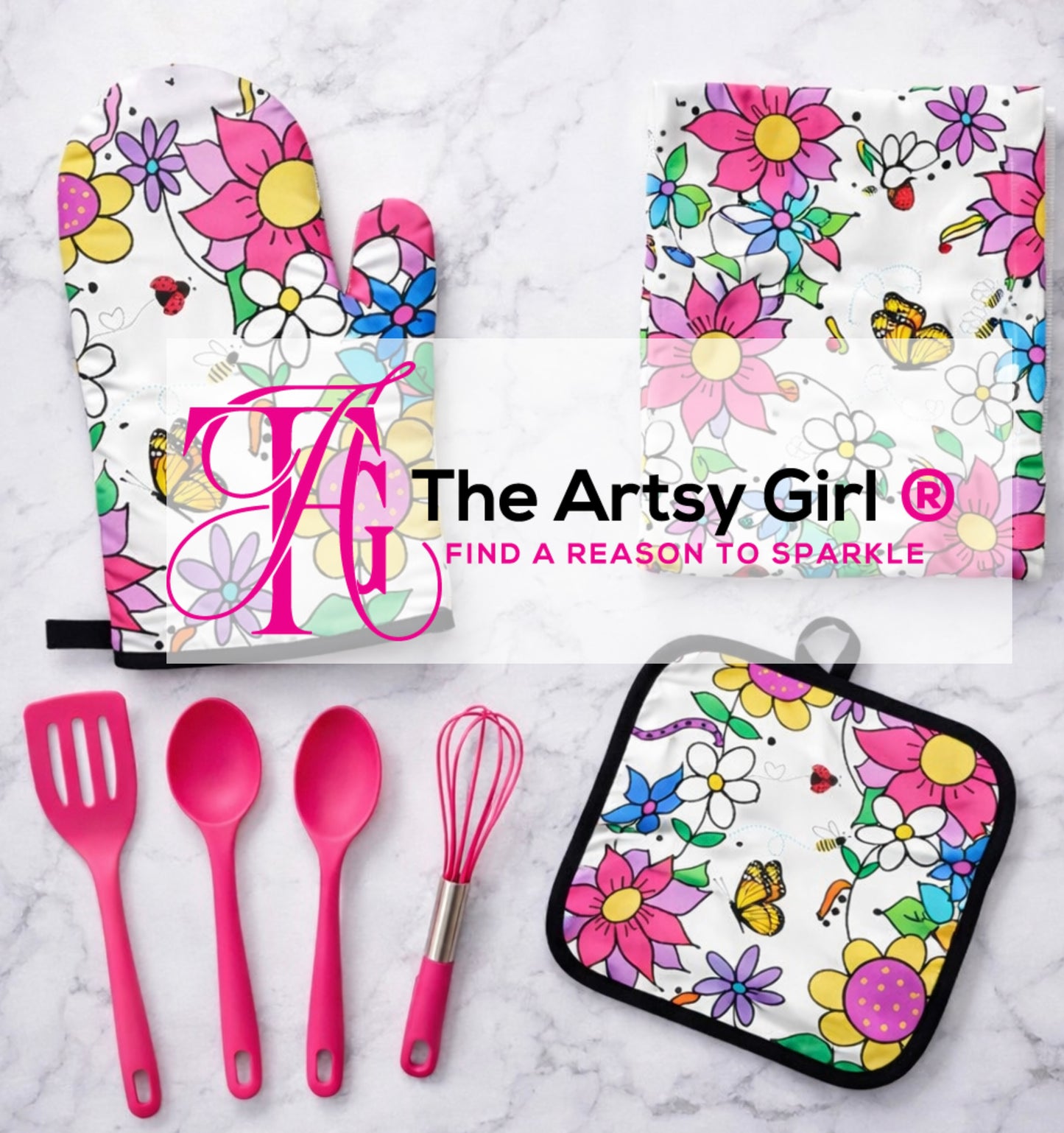 Kitchen utensils and accessories with floral designs and 'The Artsy Girl' branding on a marble surface.