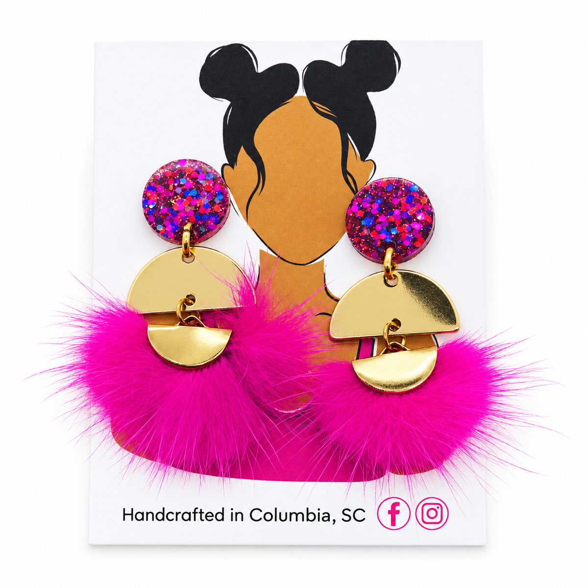 A pair of chunky drop earrings displayed on a white card. The earrings feature vibrant hot pink fluffy feathers, gold-tone metal semicircle charms, and round top studs covered in multicolor pink, blue, and purple glitter.