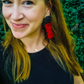 Girl wearing handmade Georgia Bulldog earrings with a black seed bead topper and the word ‘Dawgs’ spelled out.