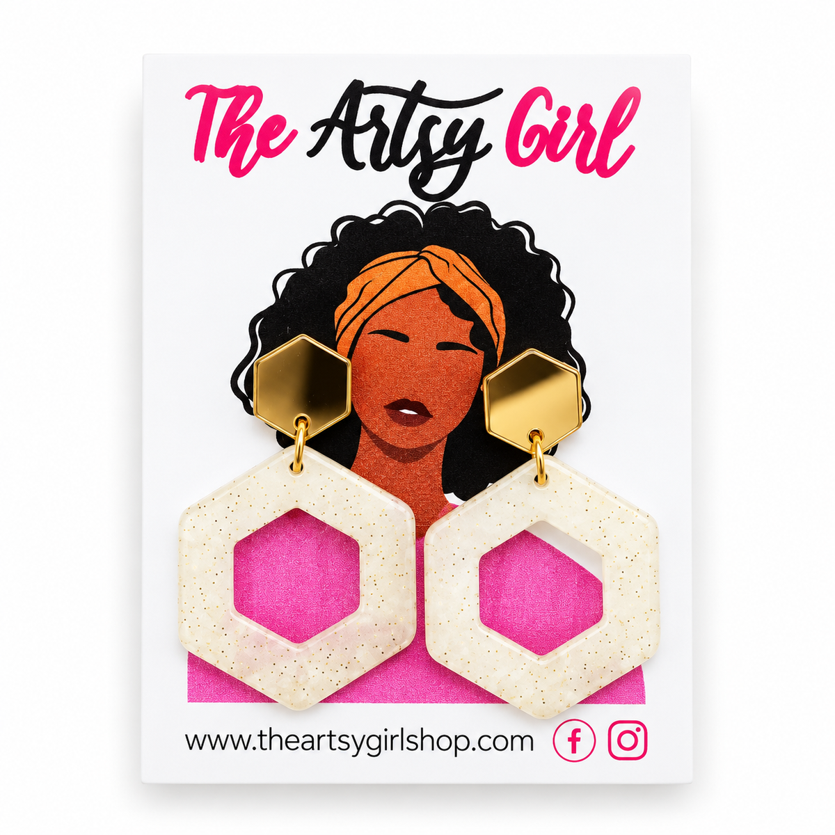 Hexagonal dangle earrings with textured cream-colored drop pieces and gold hexagonal studs, displayed on a white card labeled 'The Artsy Girl'.