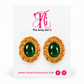 A pair of gold-toned twisted wire earrings with oval green cabochon centers, displayed on a white card branded The Artsy Girl.