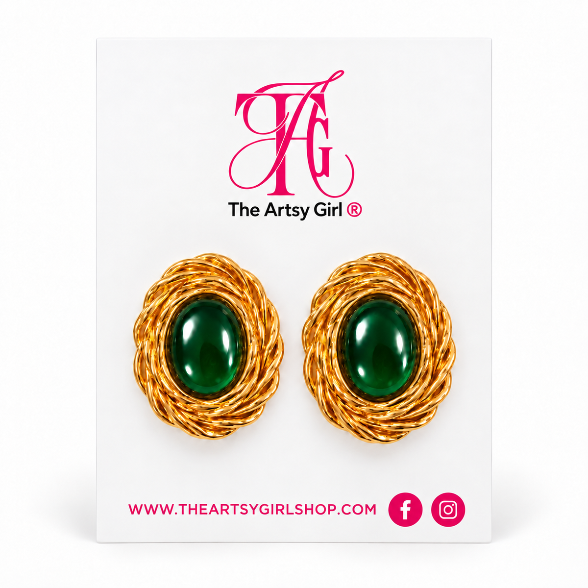 A pair of gold-toned twisted wire earrings with oval green cabochon centers, displayed on a white card branded The Artsy Girl.