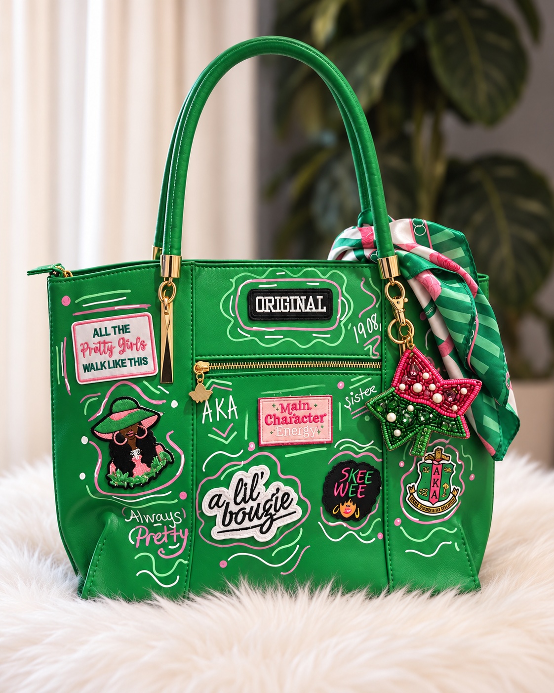 A bright green handbag with multiple decorative patches, gold-tone hardware, a striped green scarf, and an ivy lead bag charm, displayed on a white faux-fur surface with a blurred indoor background.