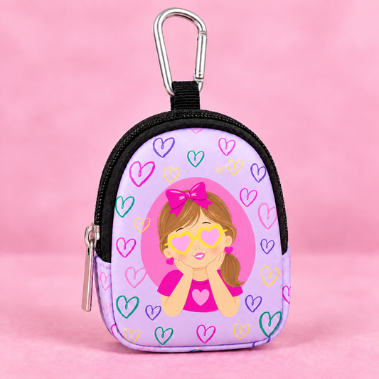 A small purple neoprene coin purse with a cartoon girl wearing heart-shaped glasses and a pink bow, surrounded by colorful hearts, featuring a black zipper, silver carabiner, and zipper pull on a pink background.