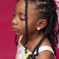 Little girl with a pink bow in her hair wearing heart glitter earrings. 