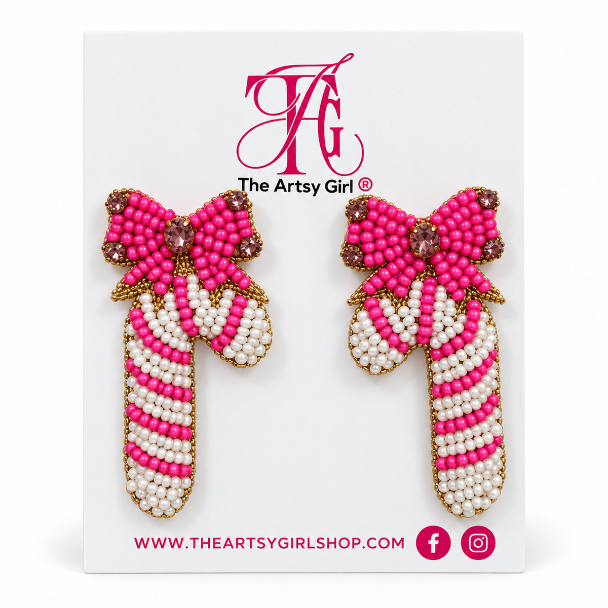Pink and white beaded candy cane earrings with red bows and gold edging on The Artsy Girl card against a white background.