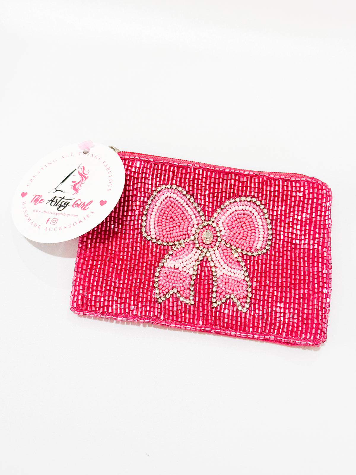 Close-up picture of a pink bow coin purse. 