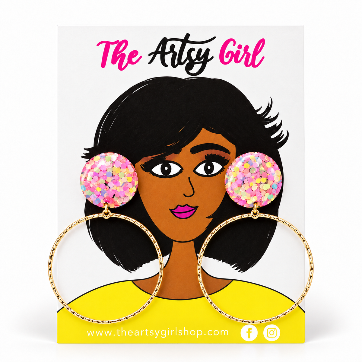Pastel confetti glitter stud earrings with thin gold-tone hoops on an illustrated The Artsy Girl card.