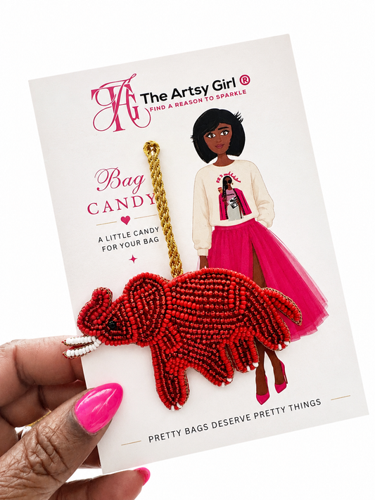 Red beaded elephant bag candy with packaging featuring 'The Artsy Girl' brand.