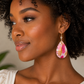 Woman wearing a colorful teardrop earring with a blurred background