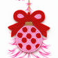 Pink and red beaded bow ornament displayed on The Artsy Girl packaging card with a sketched pink Christmas tree.