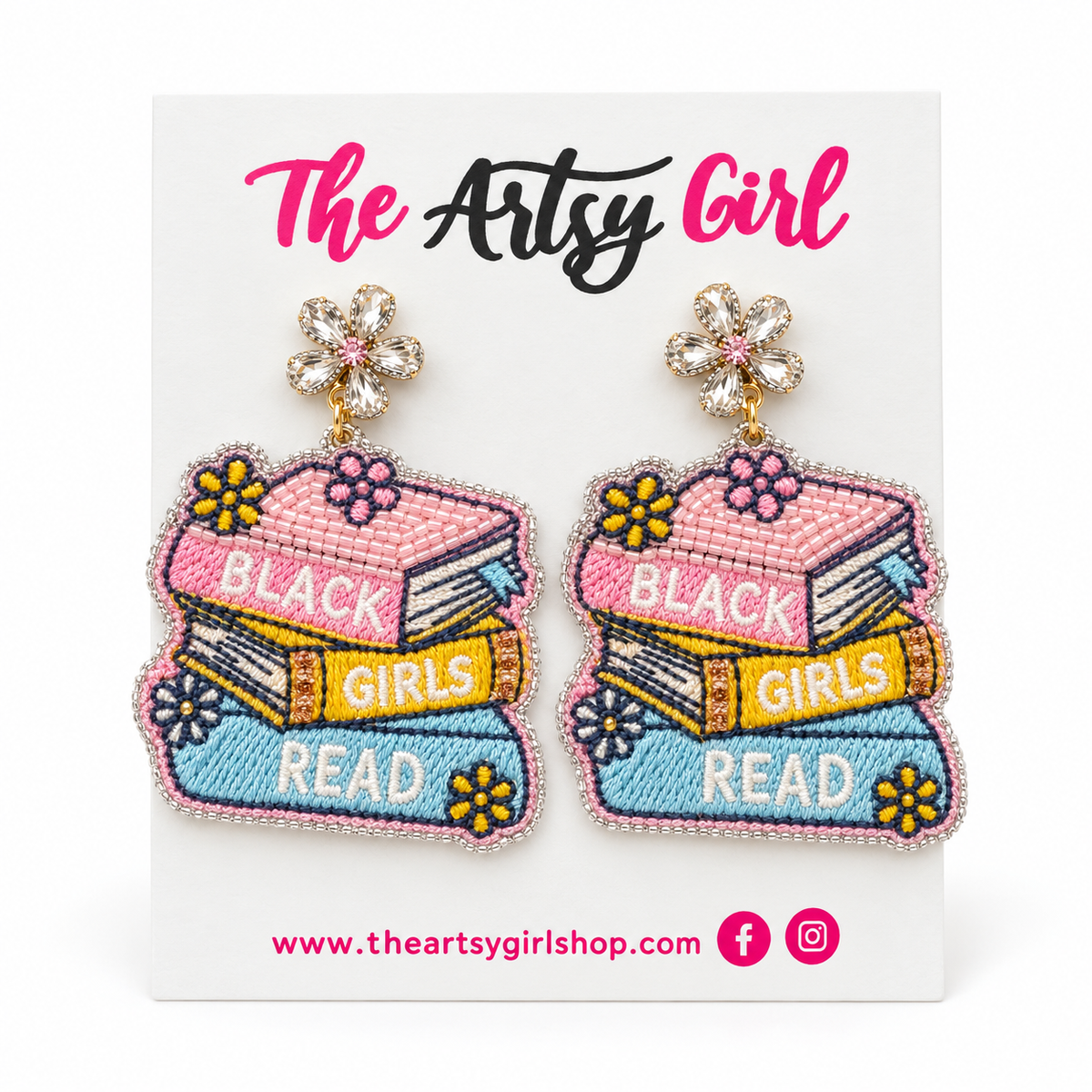Pink, yellow, and blue book-stack earrings reading “Black Girls Read,” with crystal flower tops, on an Artsy Girl card.
