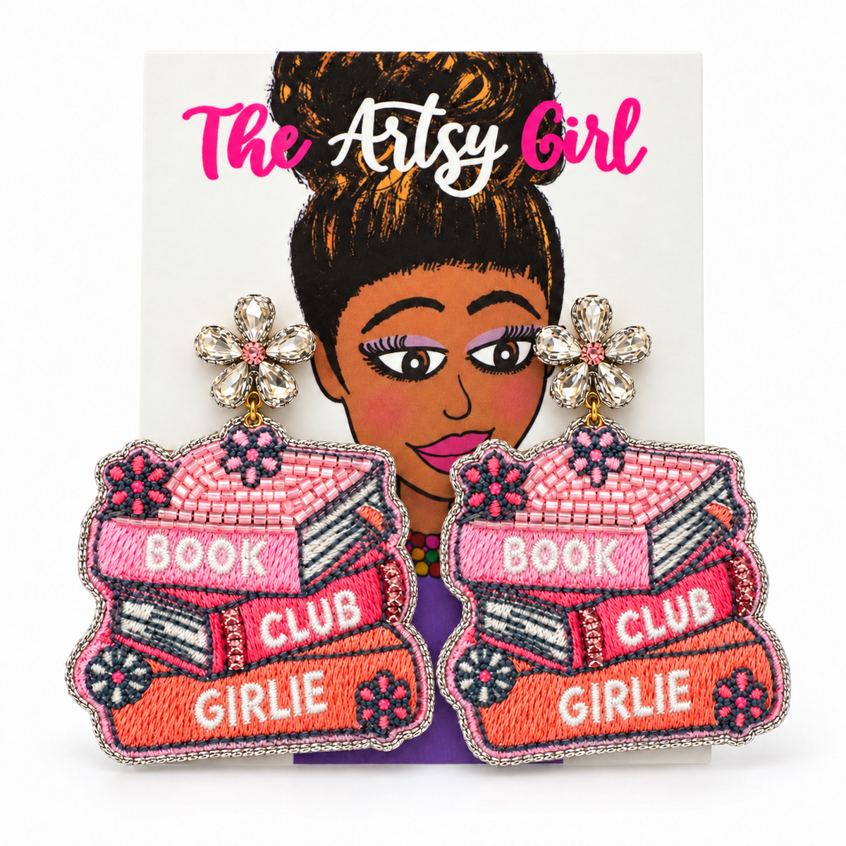 Pink and orange beaded book-stack earrings reading “Book Club Girlie,” with crystal flower tops, on an illustrated Artsy Girl card.