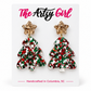 Red, green, and white confetti Christmas tree earrings with gold glitter star studs on The Artsy Girl display card.