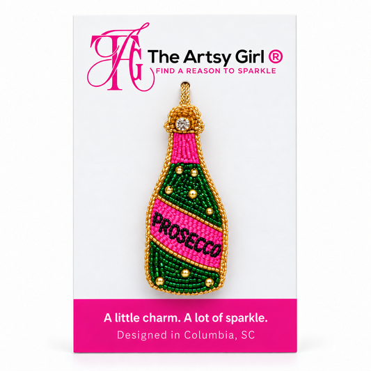 Pink and green beaded Prosecco bottle charm with gold trim displayed on The Artsy Girl packaging card.