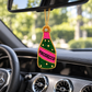 Pink and green beaded Prosecco bottle charm hanging from a rearview mirror inside a Mercedes.