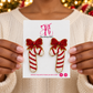 Woman holding The Artsy Girl card with red and white beaded candy cane earrings topped with red bows.