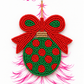 Green and red beaded Christmas bulb ornament displayed on The Artsy Girl packaging card featuring a pink sketched Christmas tree.