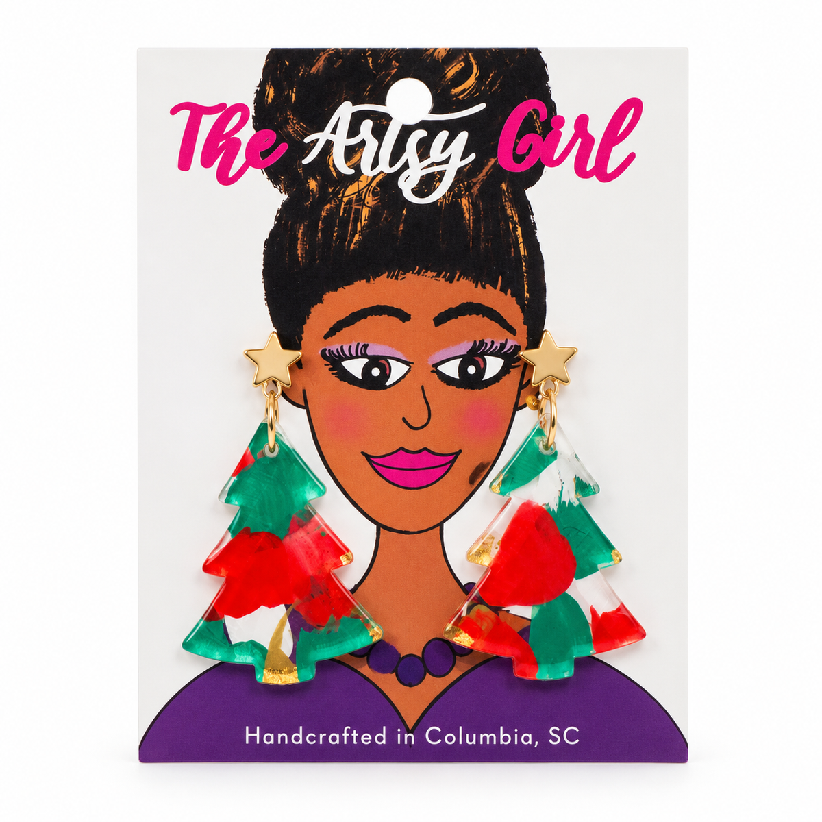 Hand-painted Christmas tree earrings with red and green accents and gold-tone star studs on an illustrated The Artsy Girl card.